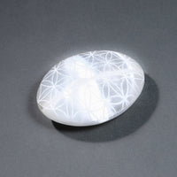 White stone with floral patterns on a gray background