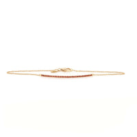 A gold bracelet with orange sapphire stones set in a barrette style clasp.