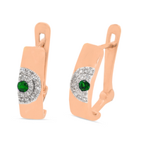 A pair of 18kt rose gold emerald and diamond earrings with a green emerald centerpiece surrounded by smaller clear diamonds set within a gold band.