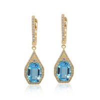 A pair of blue topaz earrings with gold and diamond accents.