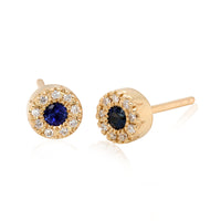 A pair of 18k gold post earrings with blue sapphire and diamond accents.