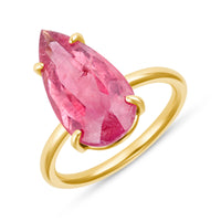 Gold ring with a pearshaped pink gemstone on a white background