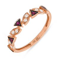 A gold ring with alternating red ruby and clear diamond stones, featuring a band design.