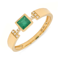 An 18k gold ring with a square-cut emerald centerpiece and smaller diamond accents along the band.
