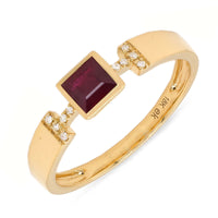 An 18k gold ring with a red square-shaped ruby centerpiece and small diamond accents on the band.