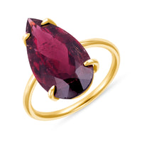 Gold ring with a large wine colored pear shaped Rubellite gemstone on a white background