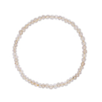 Rutilated clear quartz bracelet on a white background