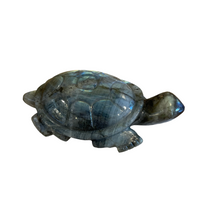 Blue stone turtle figurine on a white background