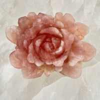 Pink rose quartz carved rose petal embedded in white stone