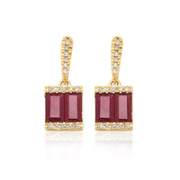Double Ruby baguettes flanked with brilliant diamonds create an illustrious pair of 18k gold earrings