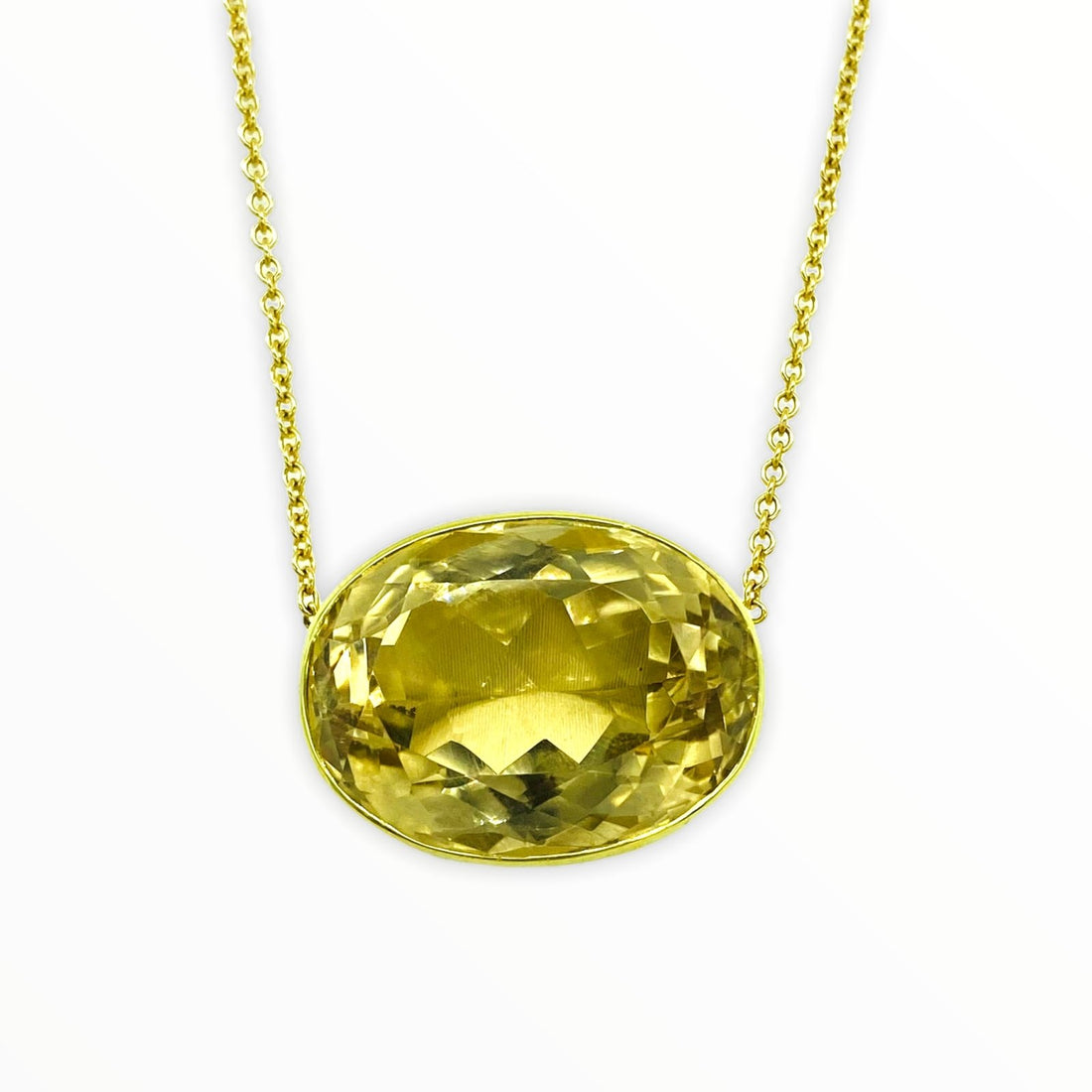 gold necklace with bright golden oval-shaped, bezel-set citrine