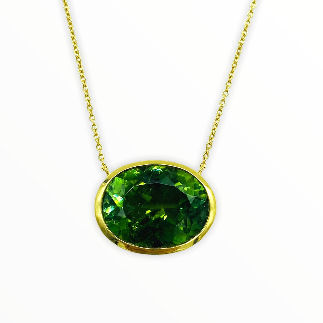 gold necklace with bright oval-shaped, bezel-set faceted pine green tourmaline gemstone
