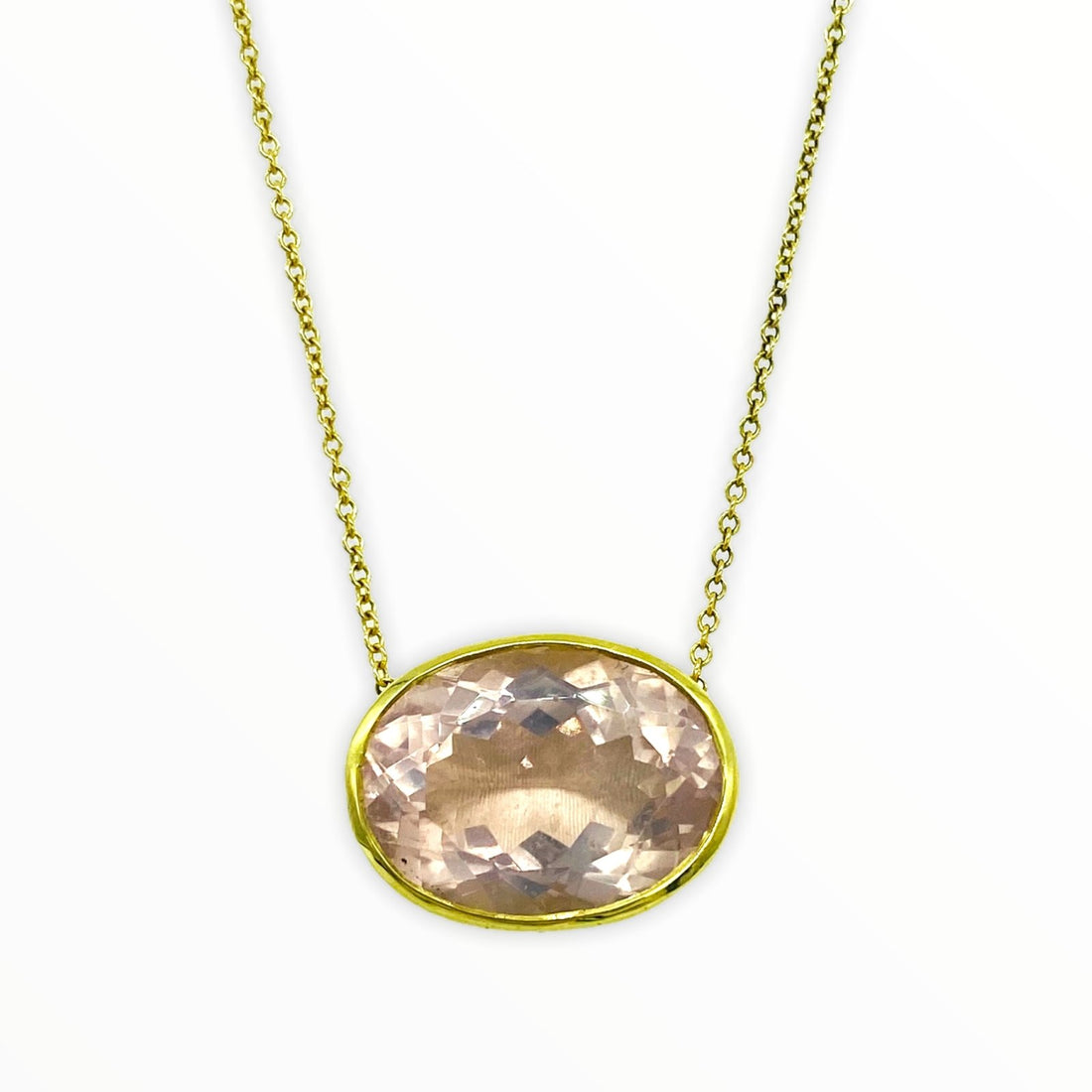 gold necklace with bright irredescent oval-shaped, bezel-set faceted rose quartz gemstone