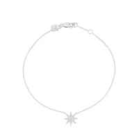 A white gold bracelet featuring a central star shape with diamonds surrounded by smaller diamonds, attached to a chain.