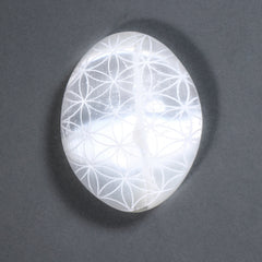 Crystal with Flower of Life pattern on a dark gray background