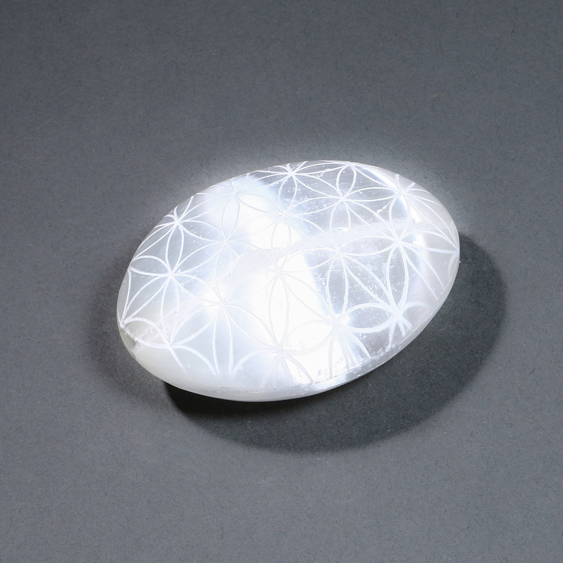 White stone with floral patterns on a gray background