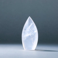 Teardrop-shaped crystal on a dark gray background