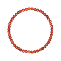 Faceted red beaded necklace on a white background