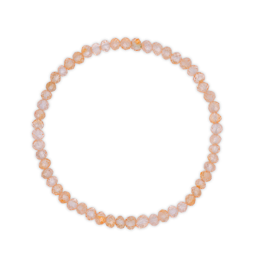 Bracelet with golden citrine faceted beads on a white background