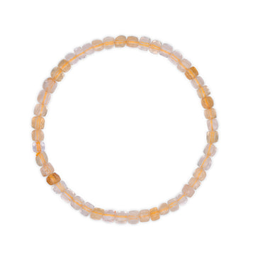 Beaded bracelet with alternating light gold and white citrine beads on a white background