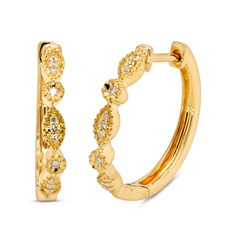 A pair of 18k gold hoop earrings adorned with diamonds.