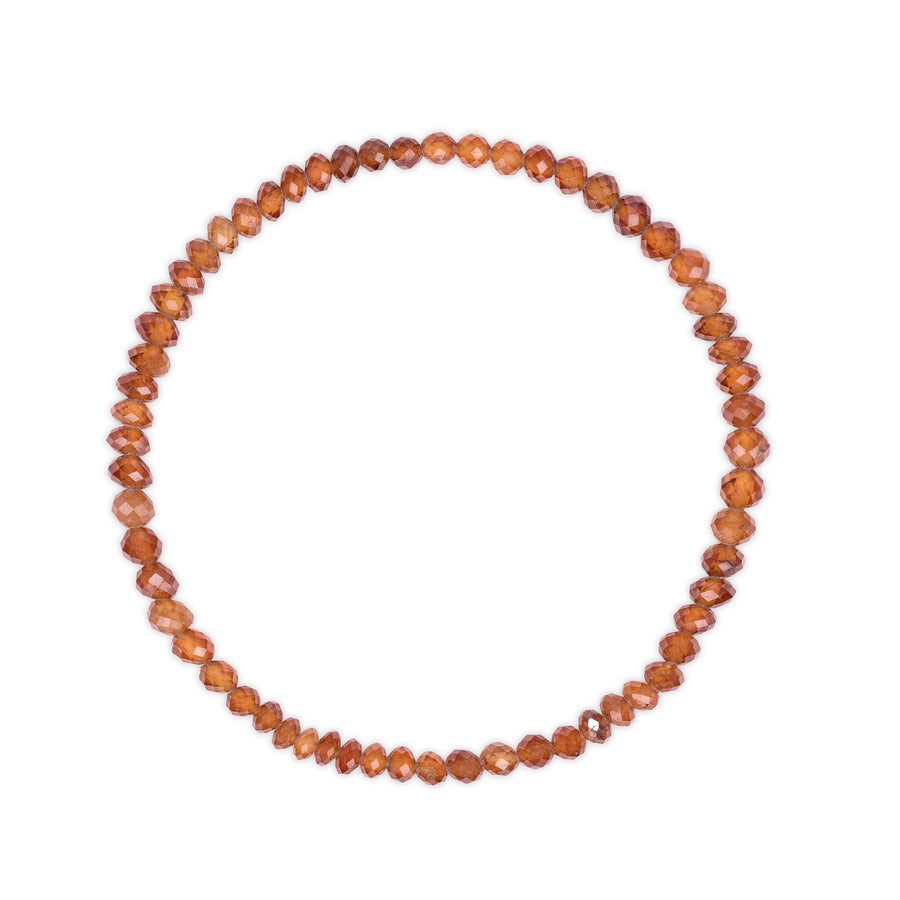 Beaded bracelet with faceted orange garnet beads on a white background