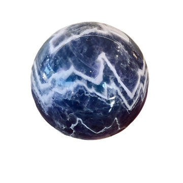 Purple chevron amethyst sphere on a against a white background