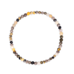 Necklace with multicolored yellow, black white and grey beads on a white background