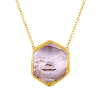 Necklace with a hexagonal crystal pendant on a white background