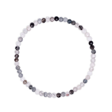 Bracelet with multicolored  white and black faceted beads with rutile inclusions visible on a white background
