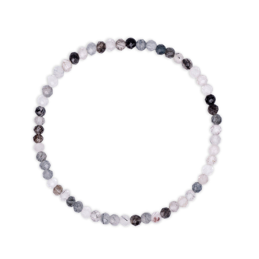 Bracelet with multicolored  white and black faceted beads with rutile inclusions visible on a white background