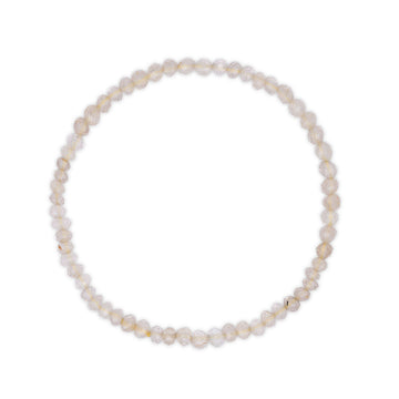 Rutilated clear quartz bracelet on a white background