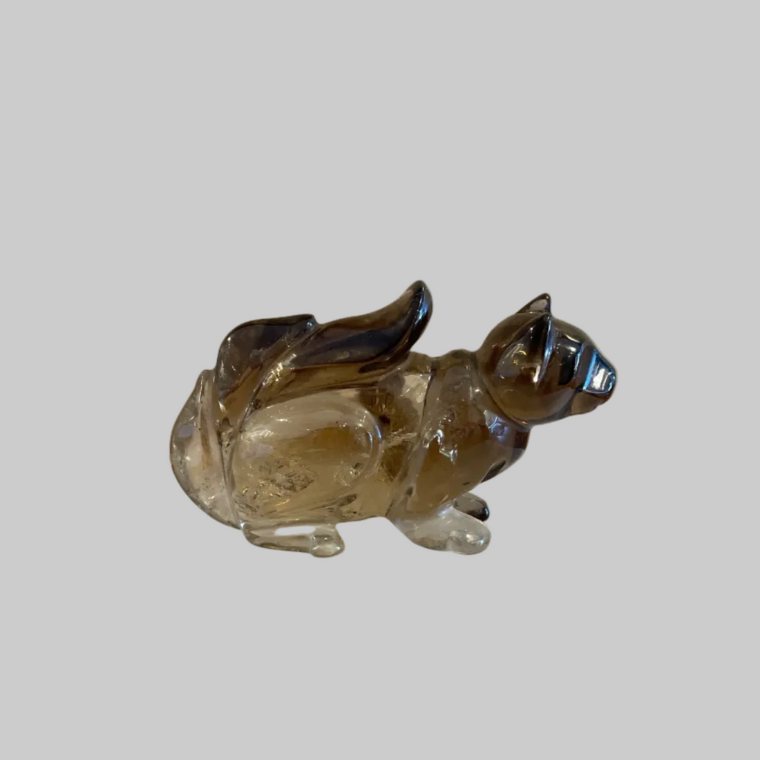 smoky citrine figurine on a plain background