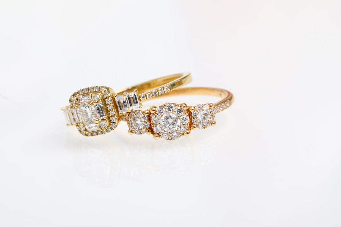 2 18kt Gold and diamond rings with diamond accents on a light gray background