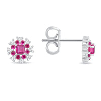 A pair of 18k gold ruby and diamond earrings with a floral design.