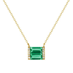 Gold necklace with pendant of double Emerald baguettes flanked with brilliant diamonds