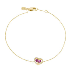 delicate gold bracelet with diamond encrusted open heart with two rubies tucked inside it.